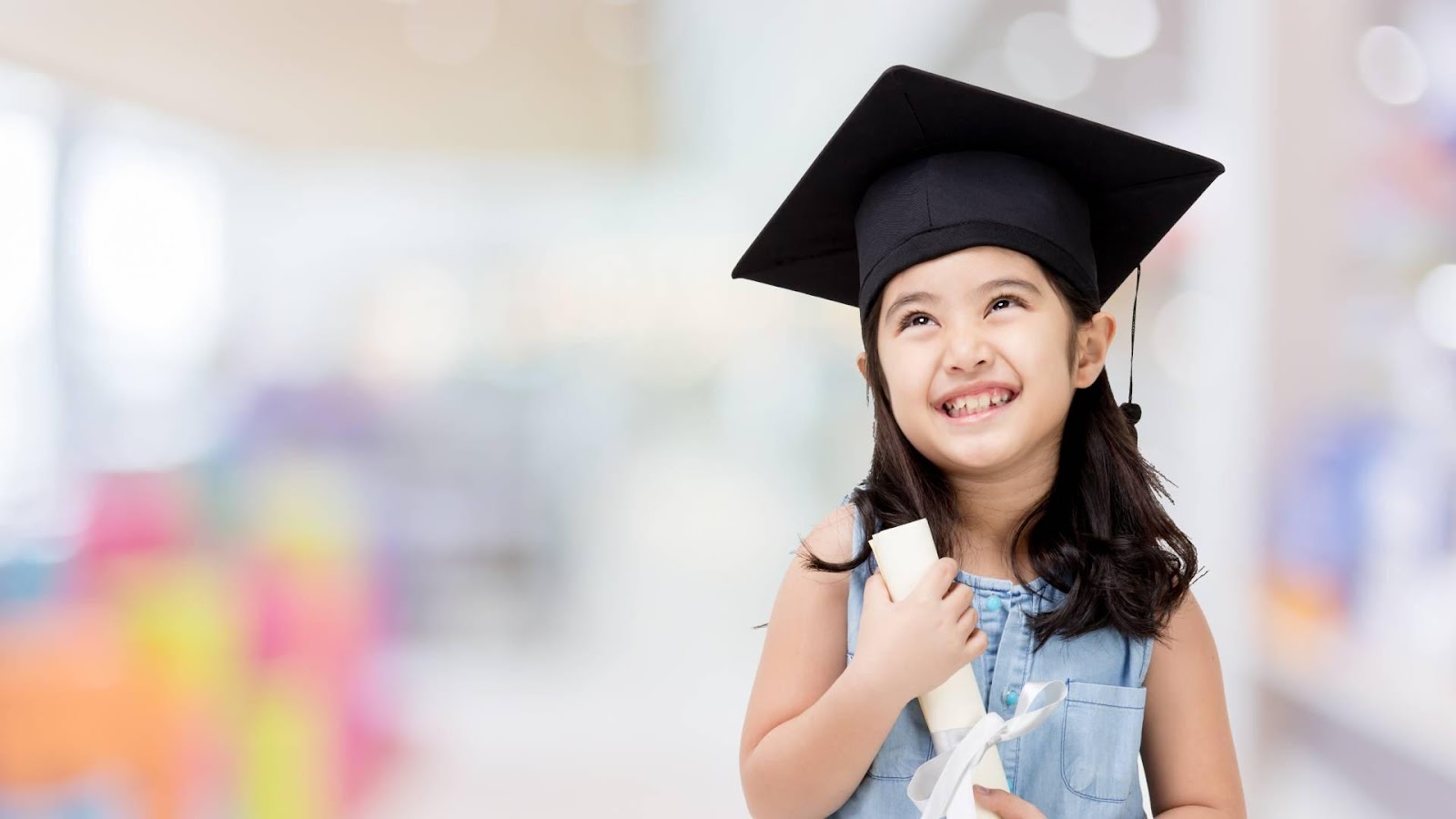 A young child wearing a graduation cap and gown

Description automatically generated