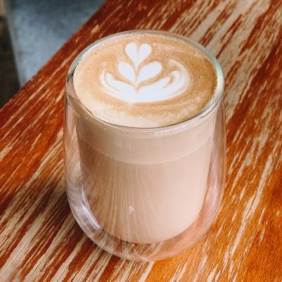 Hot latte in a glass with latte art