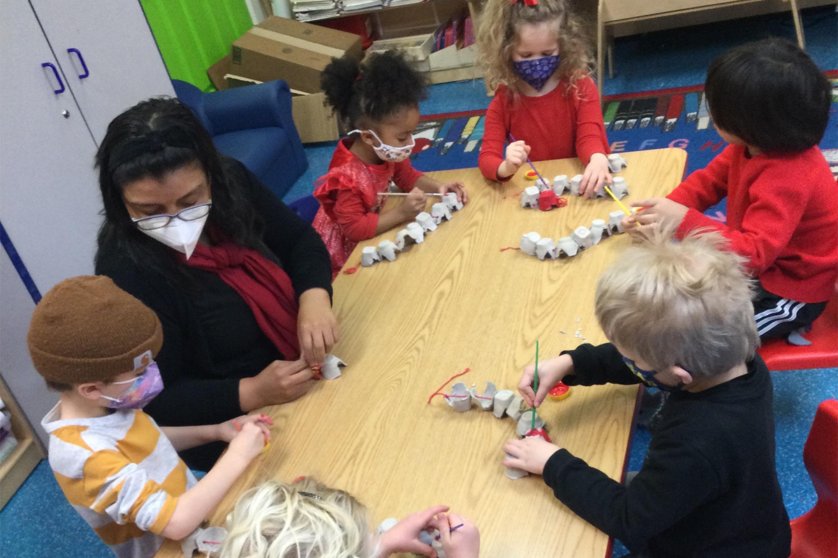 Ms. Milena casa teacher interacting with our little ones using egg cartons.