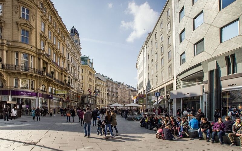 Street in Vienna with pedestrians and people watchers