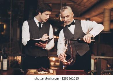 two-experienced-sommeliers-taste-wine-260nw-1288561015.jpg