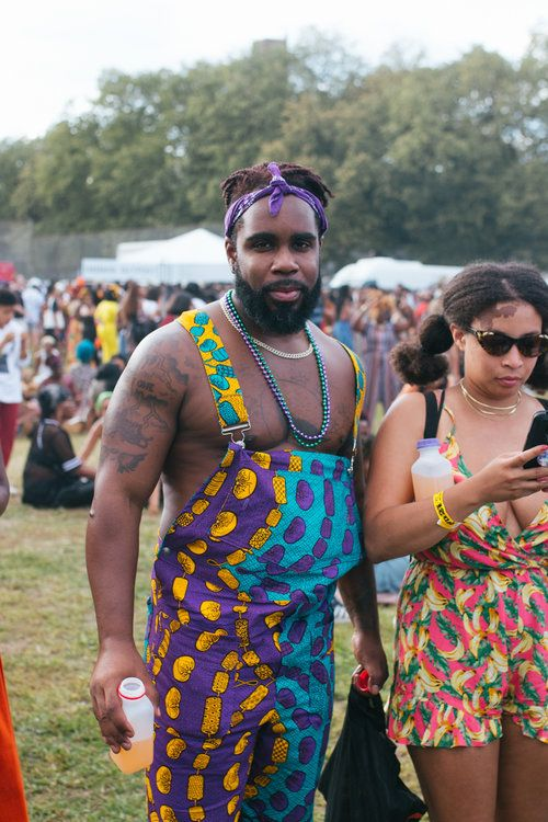 man at a festival wearing just ankara dungaree