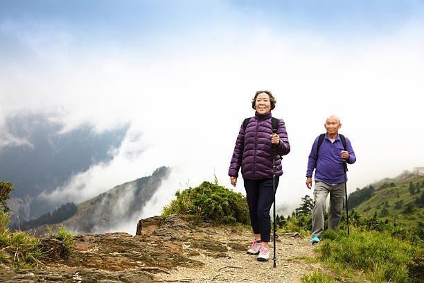happy asian senior couple hiking on the mountain  elderly hiking stock pictures, royalty-free photos & images