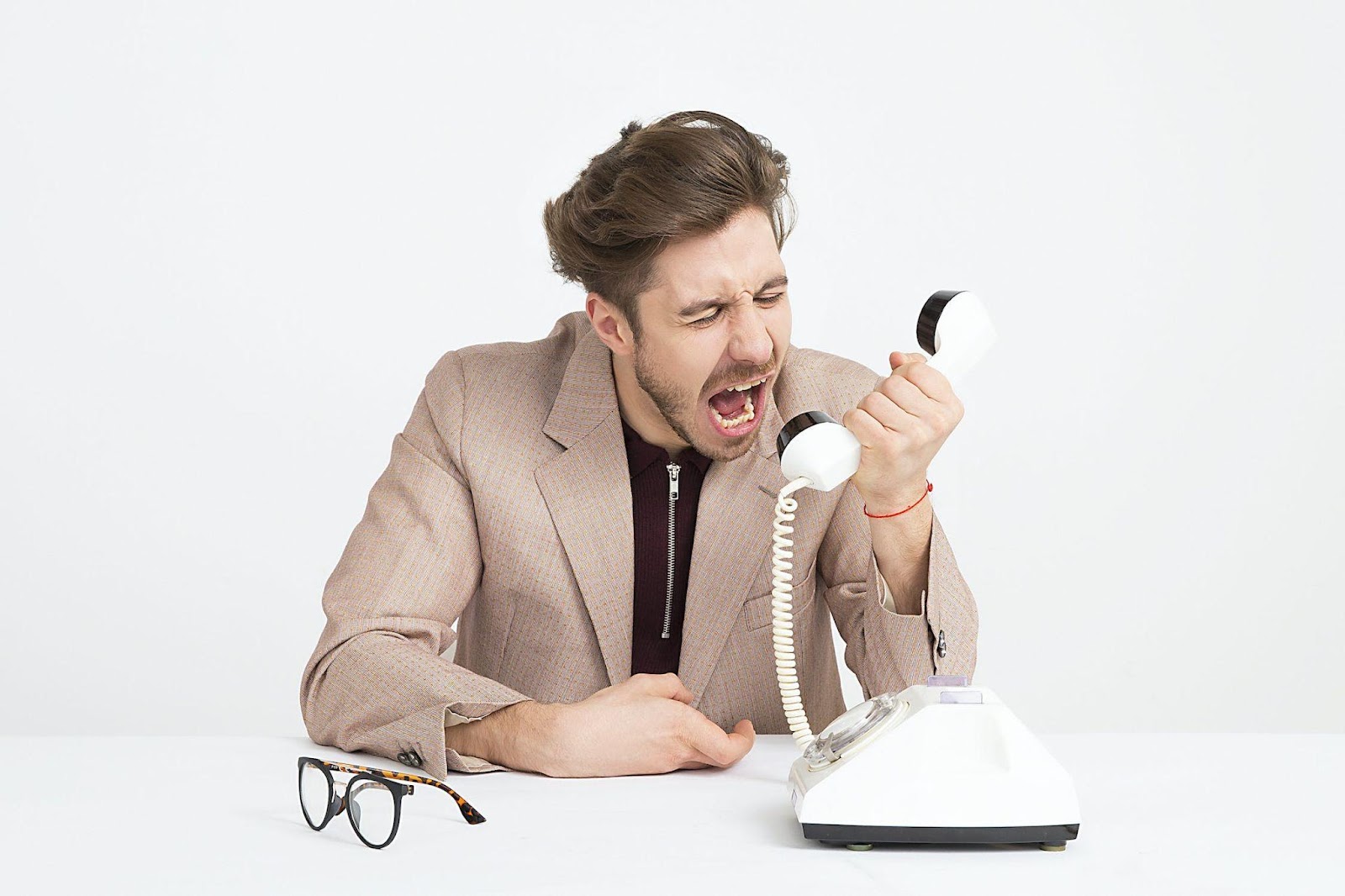 A man shouting on the phone 
