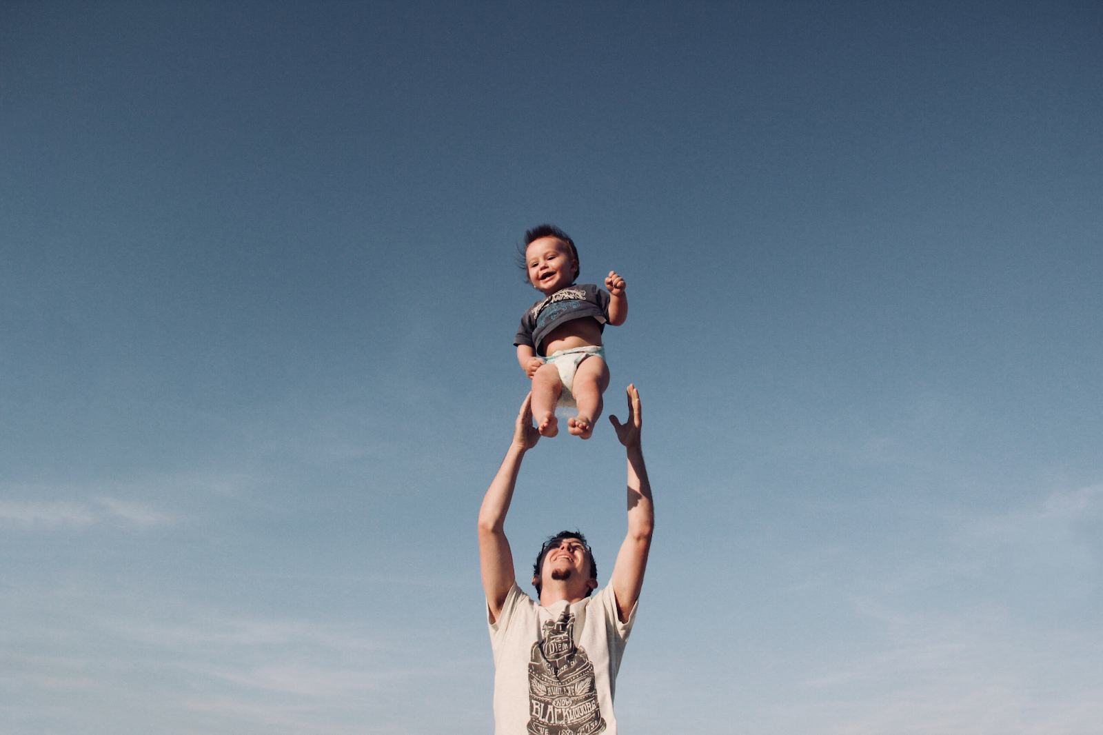 dad throwing kid in air, playing with kids, fatherhood, fit dad, strong dad, strength