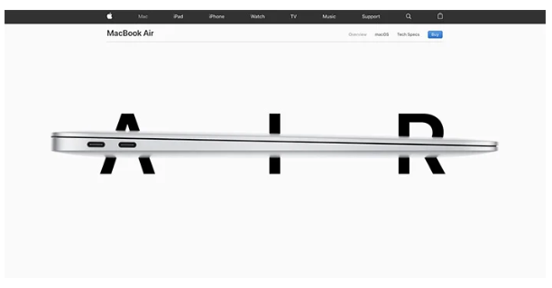 A white screen has the word AIR written across it in bold black letters. A MacBook Air computer has been horizontally placed across the letters, cutting them in half and becoming the middle bar in the A, demonstrating how to effectively use whitespace and still get the message across about the product being light and compact.