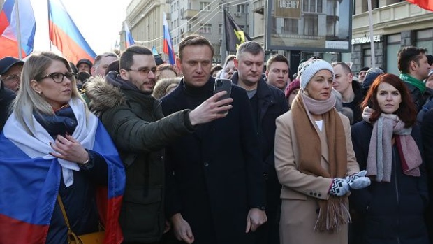 Alexey Navalny, Russian opposition leader, center, takes a selfie photograph with an attendee, as his wife Yulia, center right, stands by during a rally in Moscow, Russia, on Saturday, Feb. 29, 2019. The rally marked five years since the assassination of politician Boris Nemtsov.