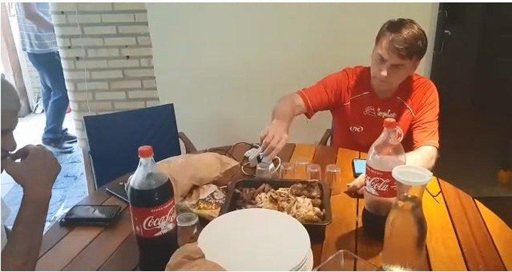 A person sitting at a table with food and drinks

Description automatically generated with low confidence