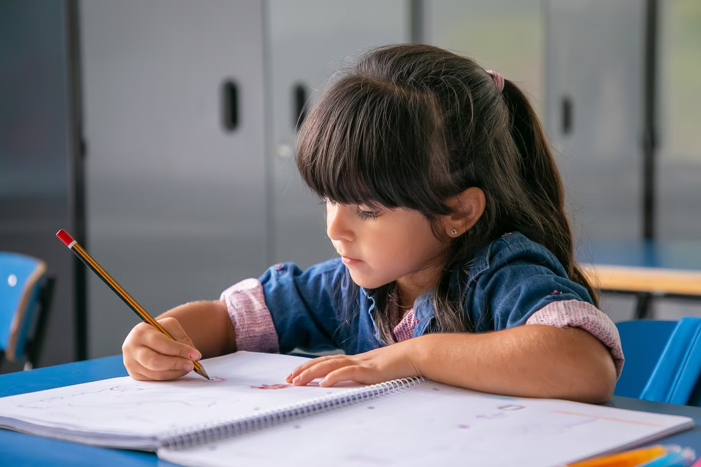A little girl writing on a paper