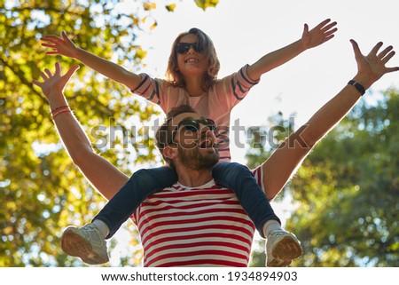 A single father and his daughter enjoying the park