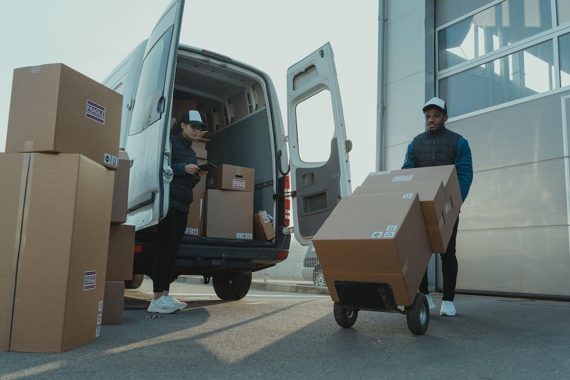 Free A Man and a Woman Working for a Delivery Company Stock Photo