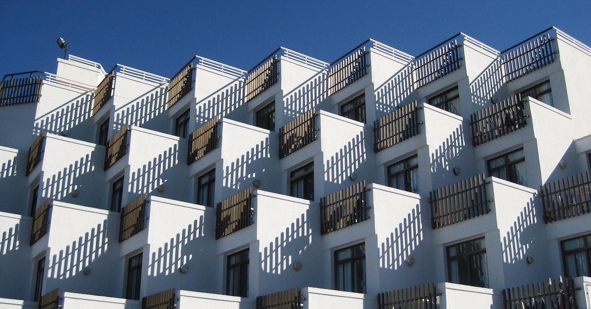 A geometric shot of condo balconies complemented by shadows.