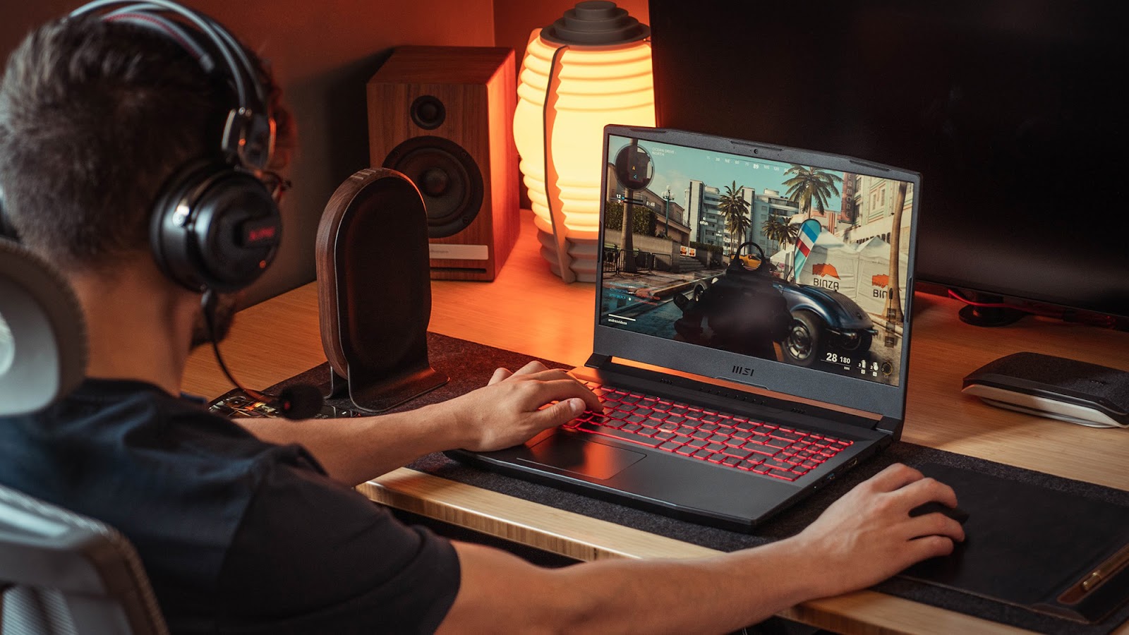 This image shows a man playing games on the MSI Katana GF76 gaming laptop.