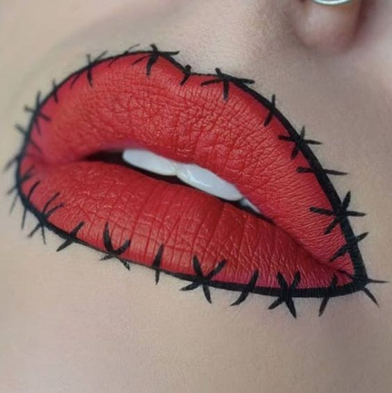 #DescriçãoDaImagem: imagem com foco em boca com batom vermelho e detalhes em contorno preto. Foto: Pinterest.
