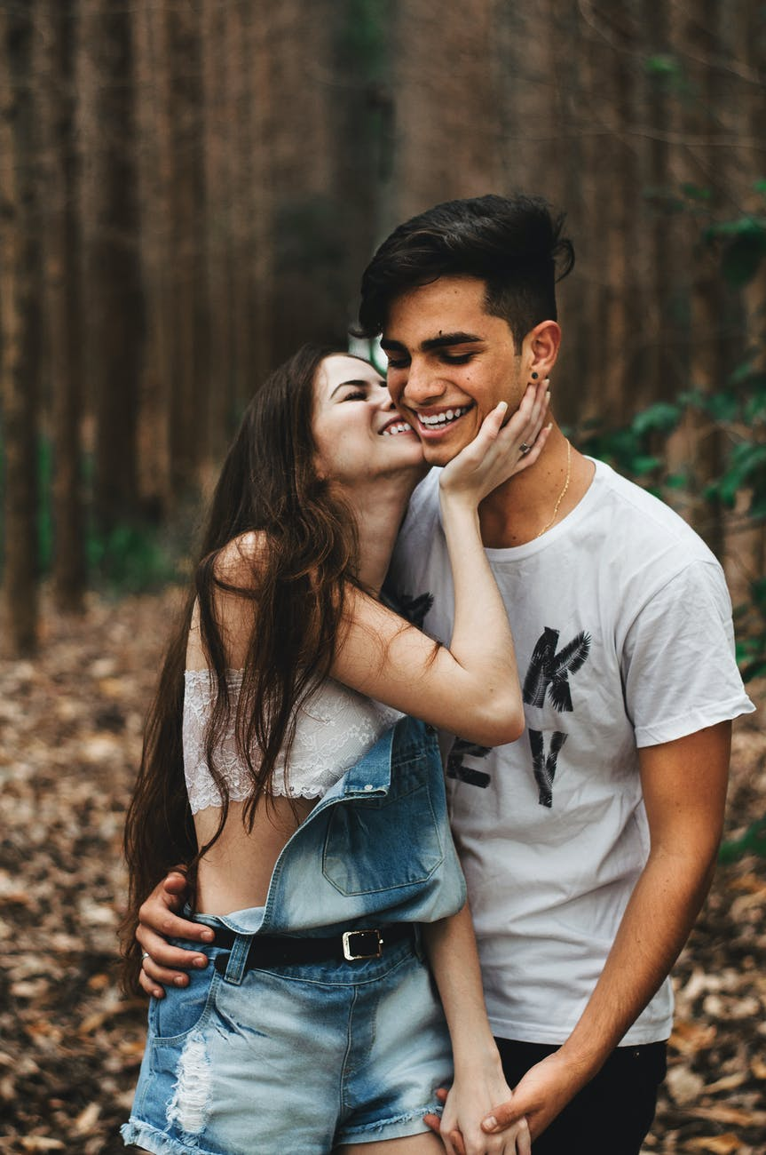 Couple in the woods being affectionate