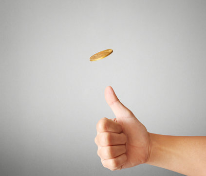 hand throwing up coin to make  decision