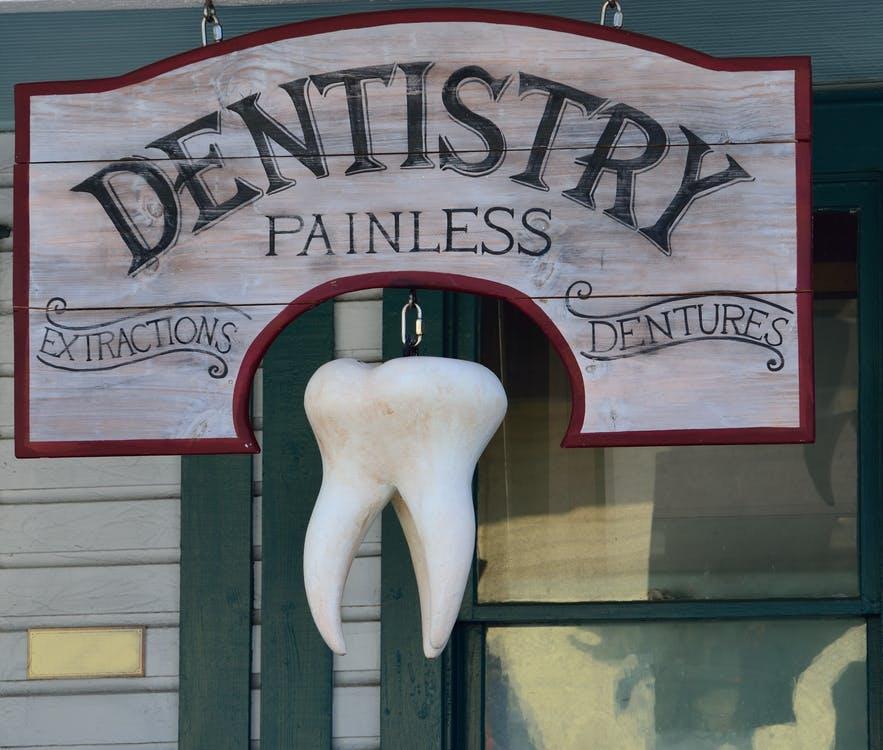 Free Dentistry Painless Signage Stock Photo
