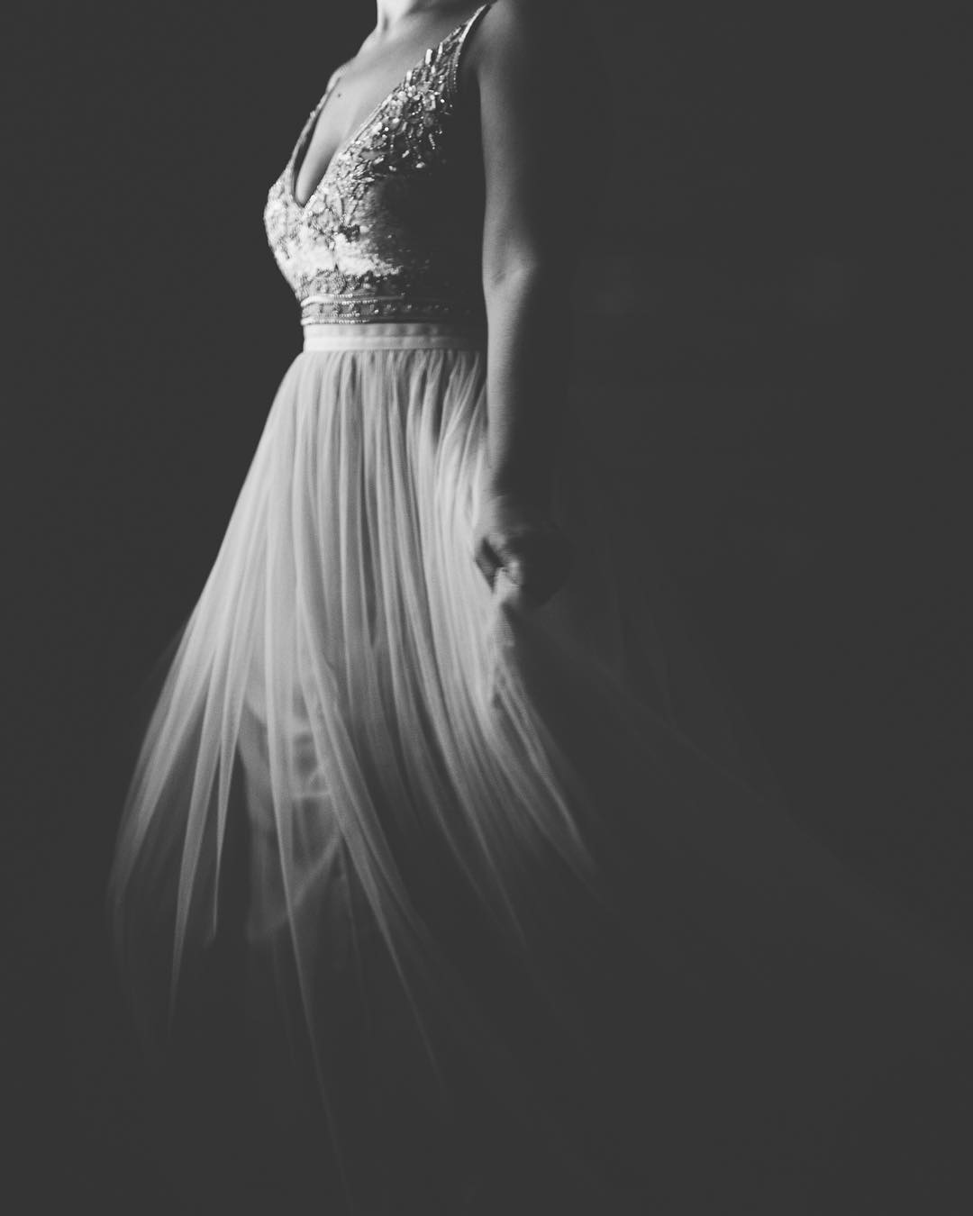 A black and white image of a bride wearing her wedding gown