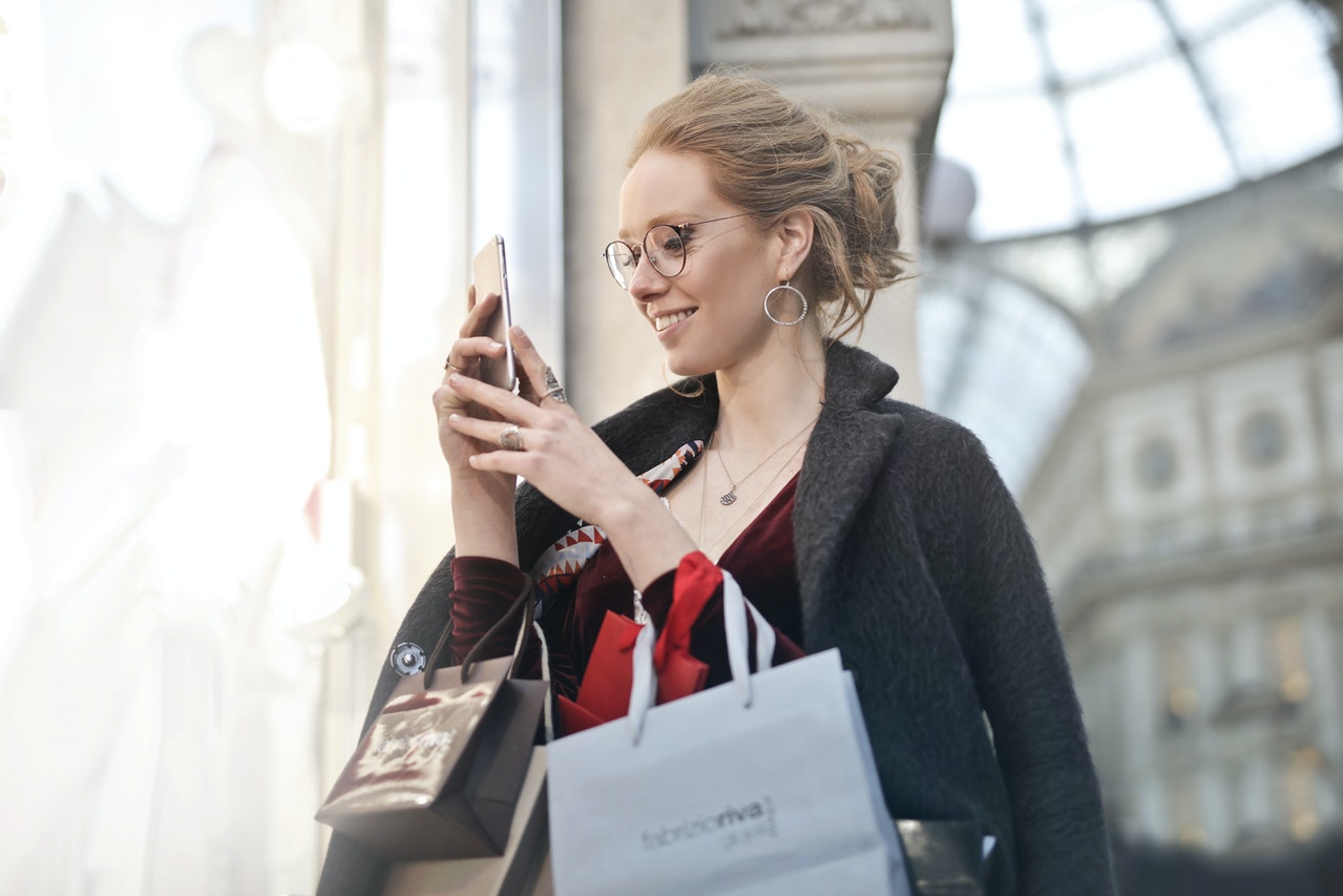 Photo of woman shopping on her smart phone
