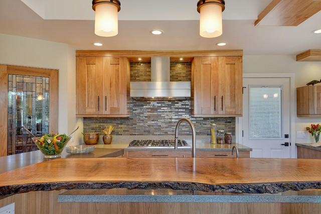 A gorgeous live edge wood countertop functions as the center of attention in this rustic contemporary kitchen.