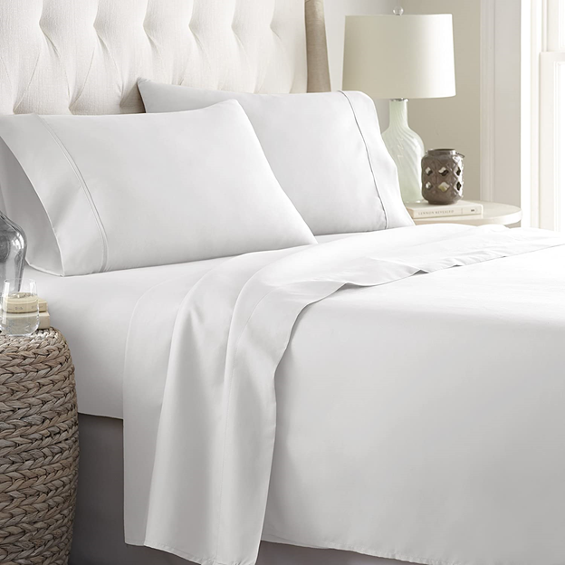 Use bedding with simple patterns to give a small apartment bedroom a lighter feel