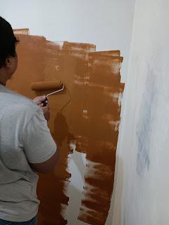 A person painting a wall

Description automatically generated with low confidence