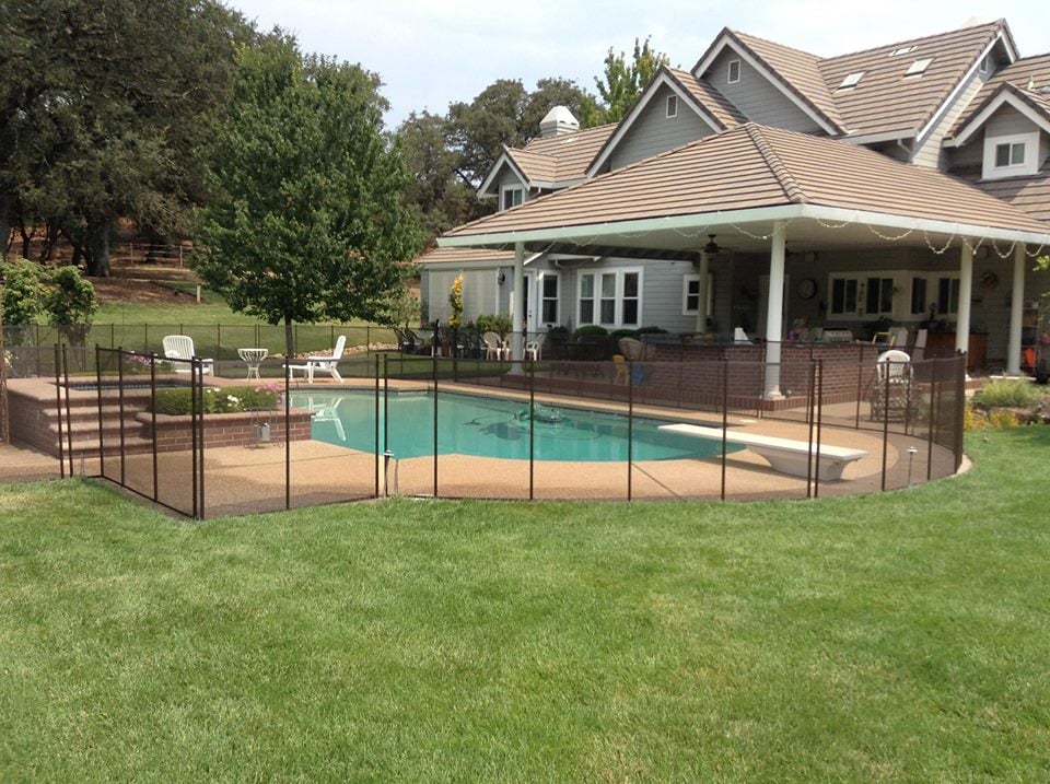 Mesh removable pool fencing installed in a backyard