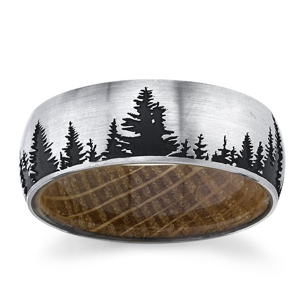 Cobalt ring with whiskey
barrel wood sleeve, laser
carved trees, and black cerakote