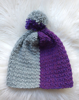 colorblock crochet hat in purple and gray on white fur