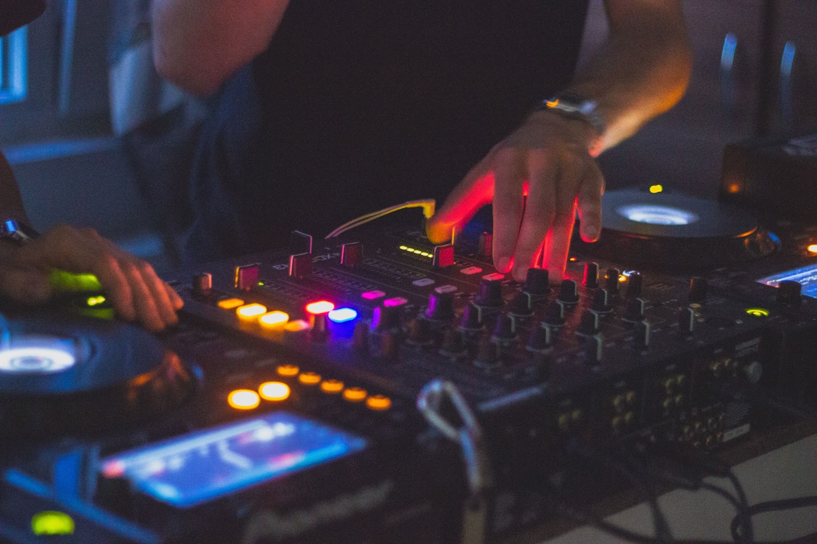 DJ mixing at rave using CDJ
