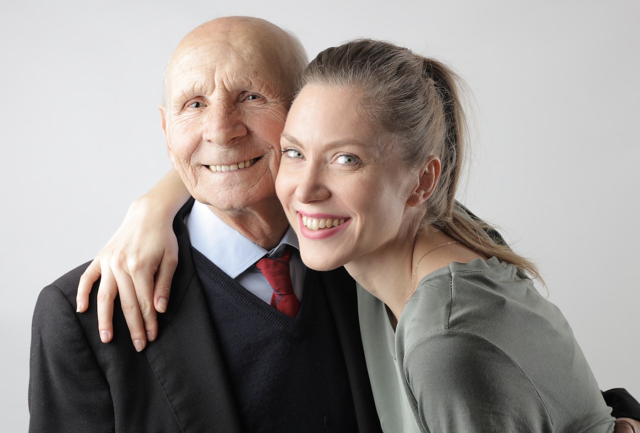 elderly father and adult daughter agreeing happily to get NDIS respite care
