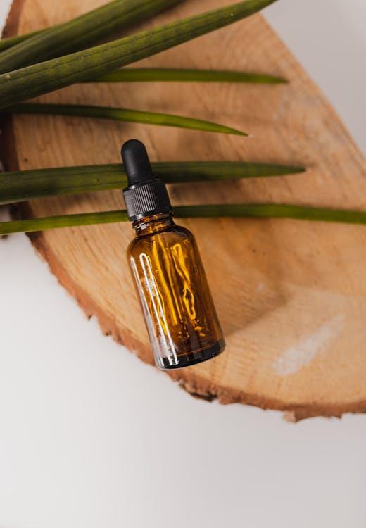 Free Small essential oil bottle on decorative tree trunk Stock Photo