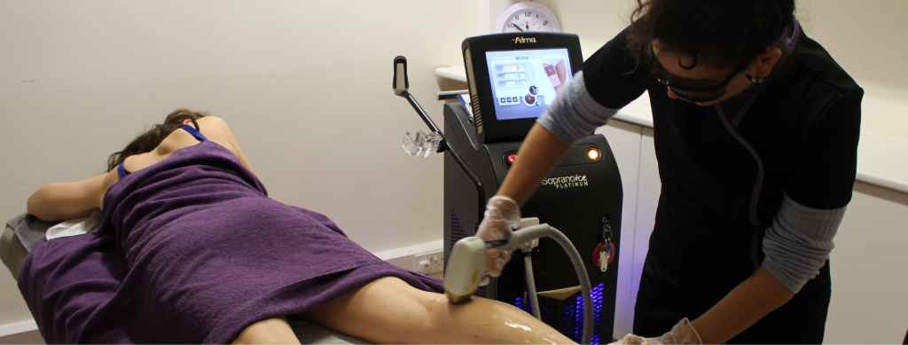 Student performing laser therapy on another student as a part of the Level 4 qualification at The London School of Beauty and Make-Up.