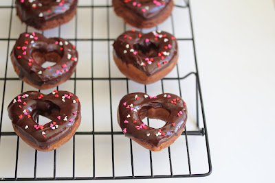 photo of chocolate donuts on a baking rack