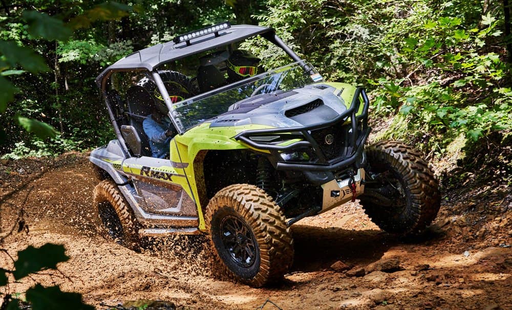 Yamaha Wolverine RMAX2 tearing through muddy terrain with unmatched power and agility