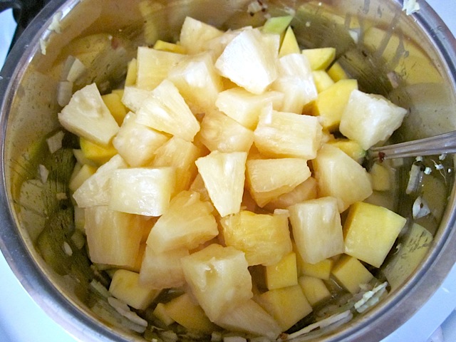 mango and pineapple added to pot of ingredients 