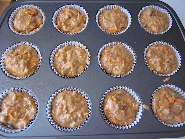 muffin pan lined with muffin cups and filled with muffin mix to top 