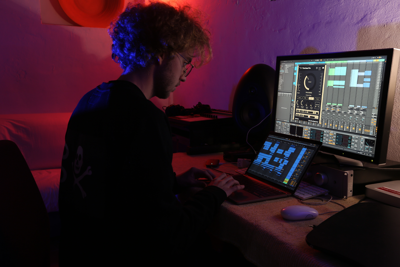 A man using laptop ang monitor