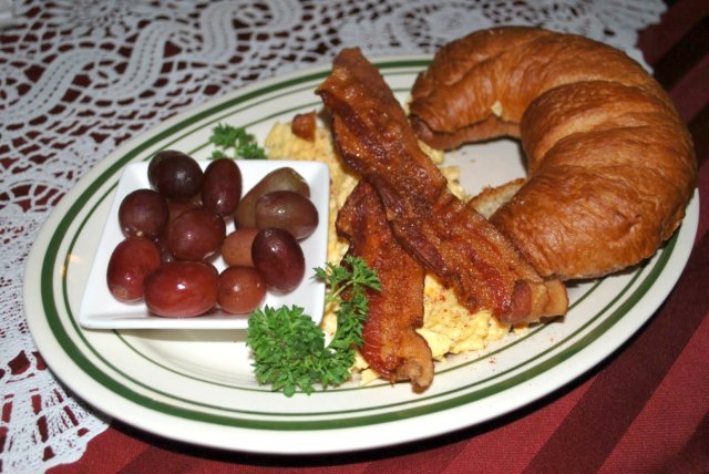 Breakfast at Mishi's Strudel Cafe This is a photo of bacons and eggs and a croissant at Mishi's Strudel Cafe.