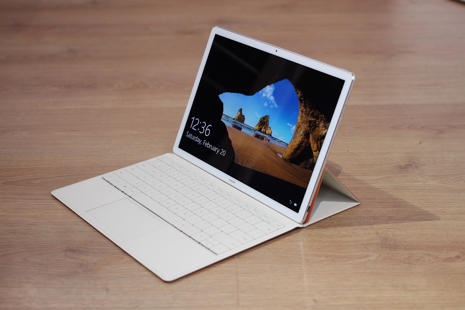 Microsoft Surface Go in the wooden desk in white color.