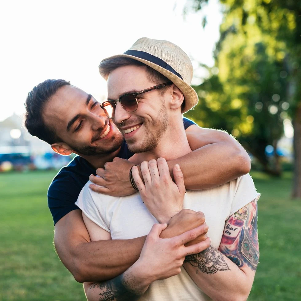 cheerful gay couple expressing love to each other while on vacation