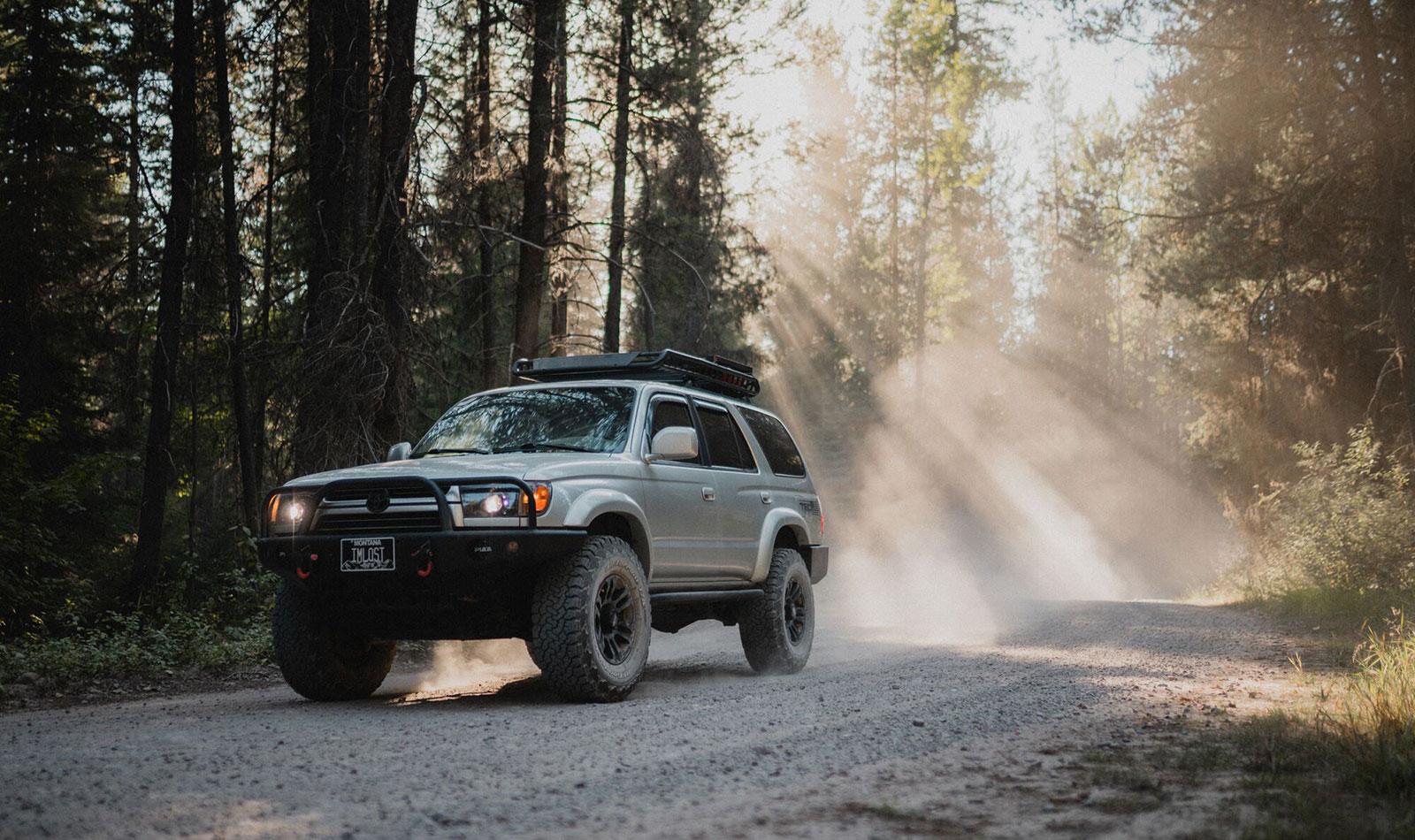 Toyota 4Runner 4x4 off road vehicle on a treelined trail 