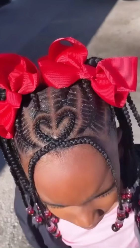 A close up view of the heart shaped braids rocked by a young girl