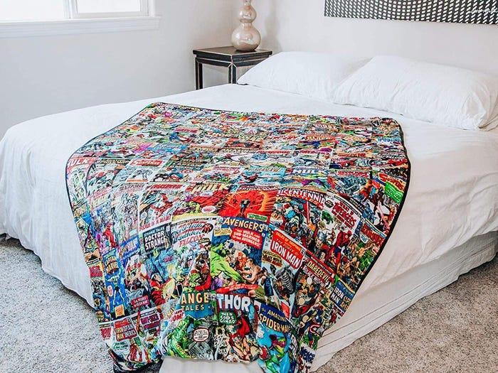 marvel comics oversized fleece throw draped on a bed