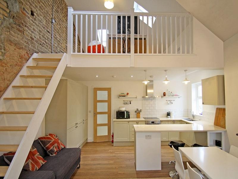 A kitchen with a table in a room
Description automatically generated