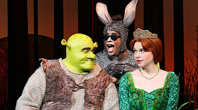 Brian d'Arcy James is shown as the title character of Shrek, left, with  Daniel Breaker as Donkey and Sutton Foster as Princess Fiona in "Shrek the Musical," now playing at the Broadway Theatre in New York. (AP Photo/Boneau/Bryan-Brown, Joan Marcus)