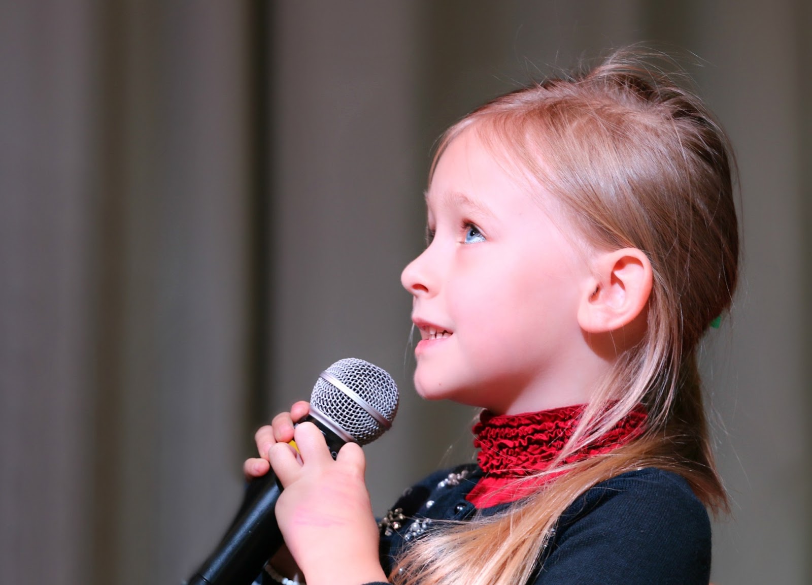 young girl with self confidence holding microphone