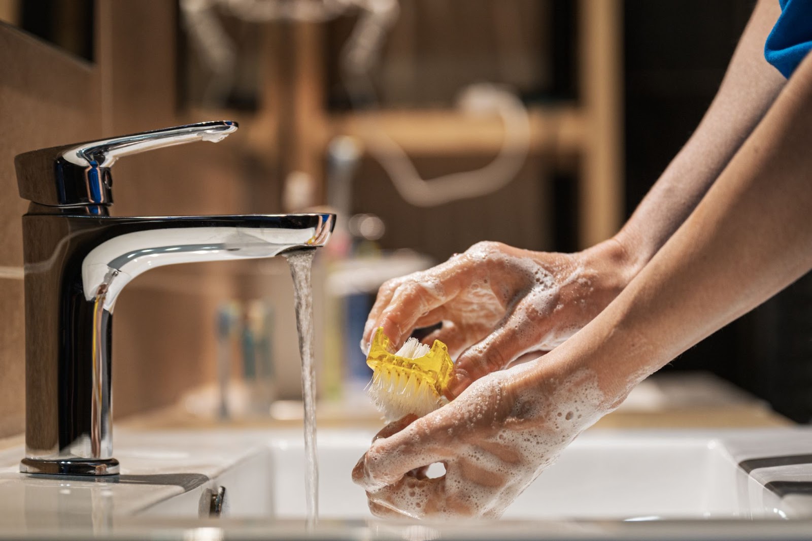 person washing hands with soap during party to prevent food poisoning