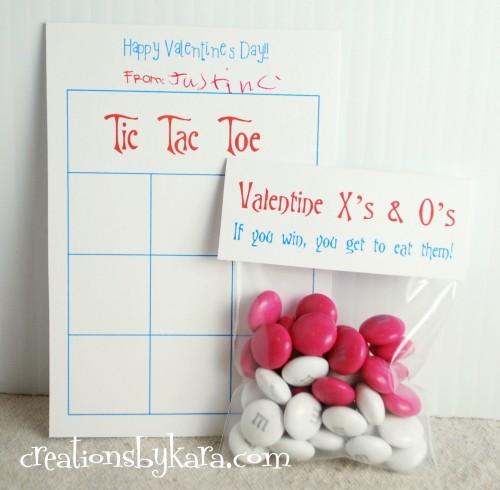 Tic Tac Toe Board with a cellophane bag containing pink and white M&Ms and a card that says, "Valentine X's & O's. If you win, you get to eat them!"