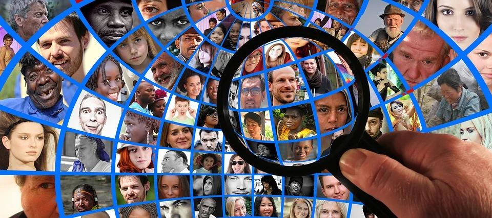 Searching for talent - magnifying glass used to see group of people